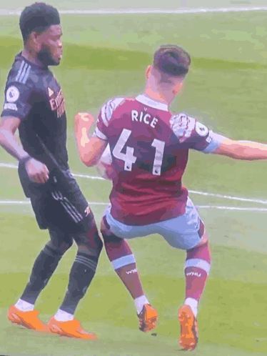 A Soccer Player Wearing A Number 41 Jersey Is Being Tackled By Another Player GIF