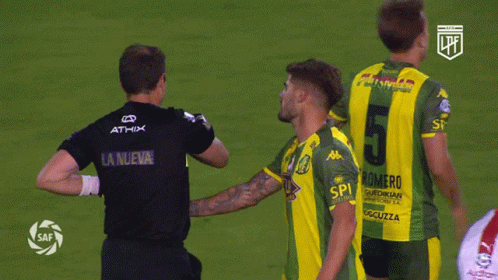 A Soccer Player Wearing A Number 5 Jersey Talks To Another Player GIF