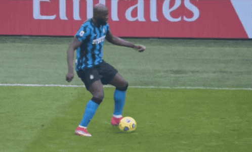 a soccer player wearing a number 7 jersey is being tackled by another player