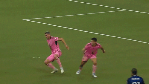 A Soccer Player Wearing A Number 77 Jersey Stands In Front Of A Net GIF