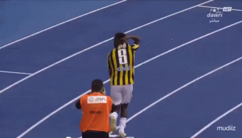 A Soccer Player Wearing A Number 8 Jersey Stands On A Track GIF