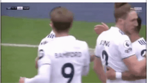 A Soccer Player Wearing A Number 9 Jersey Is Hugging Another Player GIF