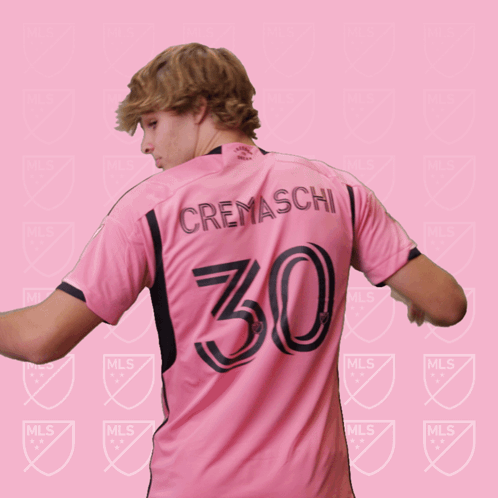 a soccer player wearing a pink jersey with the number 30 on it