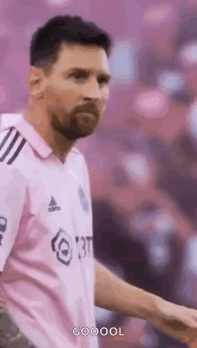 A Soccer Player Wearing A Pink Shirt Is Standing On A Field . GIF