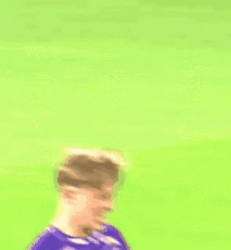 A Soccer Player Wearing A Purple Jersey With A White Circle On The Front GIF