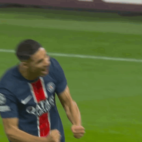 a soccer player wearing a qatar airlines jersey