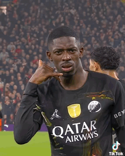 A Soccer Player Wearing A Qatar Airways Jersey Is Making A Call Me Gesture GIF