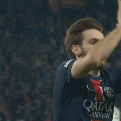 A Soccer Player Wearing A Qatar Airways Jersey Looks Up At The Sky GIF