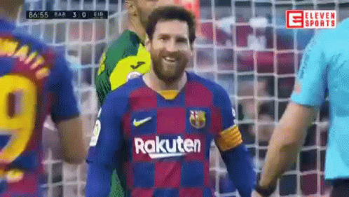 A Soccer Player Wearing A Rakuten Jersey Is Smiling While Standing Next To A Referee . GIF