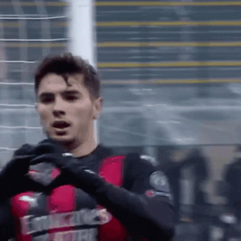 A Soccer Player Wearing A Red And Black Jersey That Says Emirates GIF