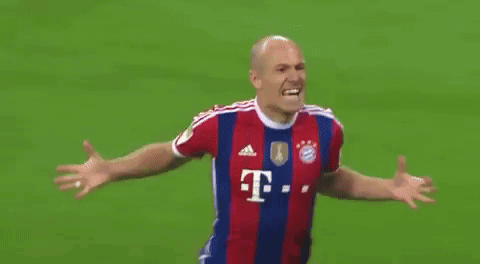 a soccer player wearing a red and blue striped jersey with the letter t on it