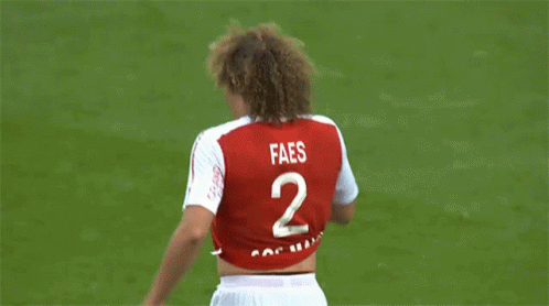 A Soccer Player Wearing A Red And White Jersey That Says Restez A La Maison GIF