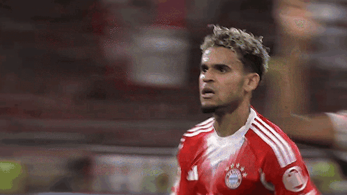 A Soccer Player Wearing A Red And White Jersey With The Number 21 On It GIF