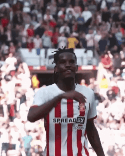 a soccer player wearing a red and white striped jersey that says spreadex sports