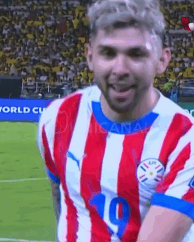 a soccer player wearing a red and white striped jersey with the number 10 on it