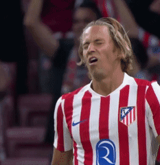 a soccer player wearing a red and white striped shirt with the letter r on it