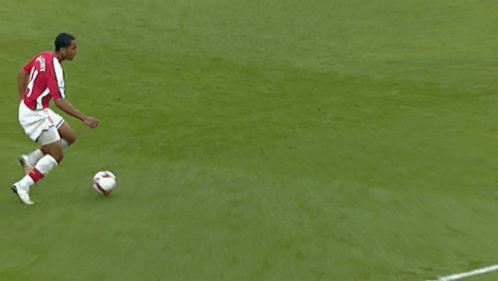 A Soccer Player Wearing A Red Jersey With The Name Alvarez On The Back Is Kicking The Ball GIF