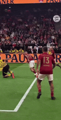 a soccer player wearing a red jersey with the number 13 on it