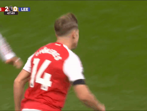 A Soccer Player Wearing A Red Jersey With The Number 14 On It GIF