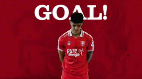 A Soccer Player Wearing A Red Pure Energie Shirt Celebrates A Goal GIF