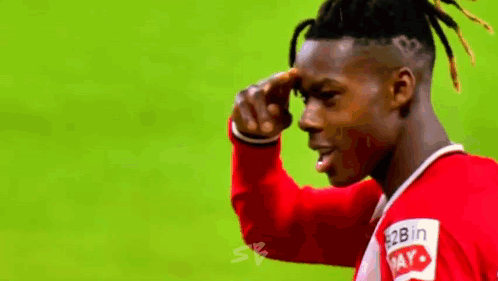 a soccer player wearing a red shirt that says 2b in may