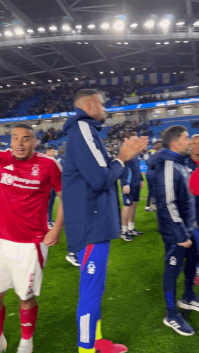 a soccer player wearing a red shirt that says liverpool on it