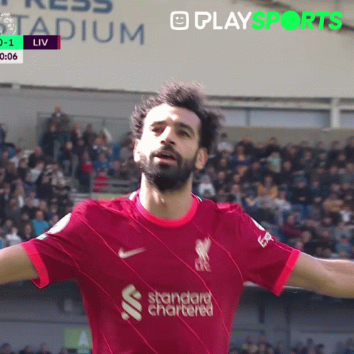 A Soccer Player Wearing A Red Shirt That Says Standard Chartered On It GIF