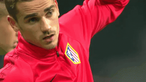 A Soccer Player Wearing A Red Shirt With The Letters Atm On It Is Standing On A Field . GIF