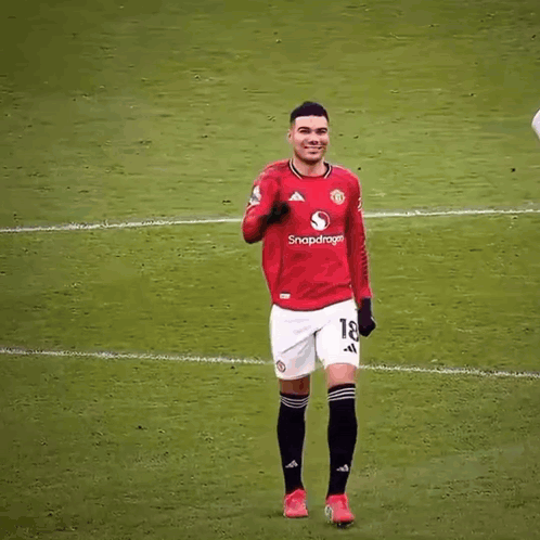 a soccer player wearing a red shirt with the number 7 on it