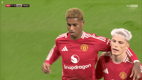 A Soccer Player Wearing A Red Snapdragon Jersey Holds His Finger To His Ear GIF