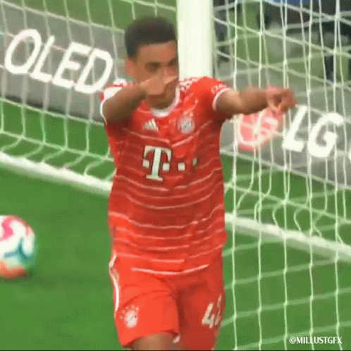A Soccer Player Wearing A Red T-Mobile Jersey Is Celebrating A Goal GIF