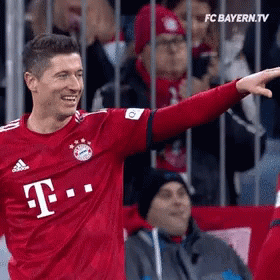 A Soccer Player Wearing A Red T-Mobile Jersey Is Pointing GIF