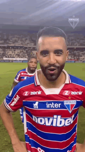 A Soccer Player Wearing A Red , White And Blue Jersey With The Word Novibet On It . GIF