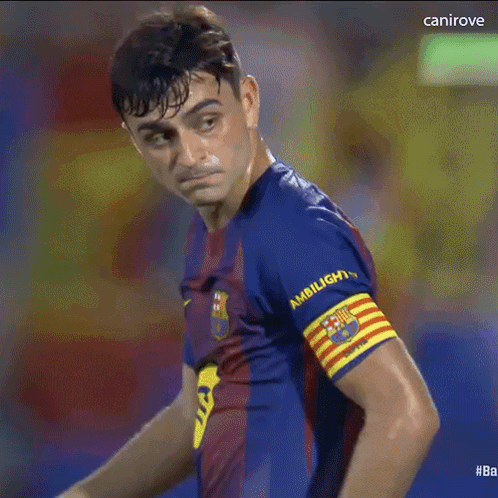 a soccer player wearing a shirt that says ambilight is standing in the rain .