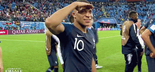 A Soccer Player Wearing A Shirt With The Number 10 On It Salutes The Crowd . GIF