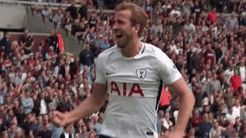 A Soccer Player Wearing A White Aia Jersey Is Standing In Front Of A Crowd . GIF