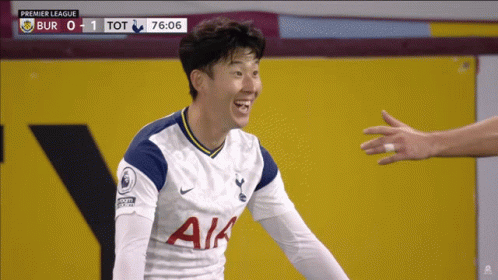 A Soccer Player Wearing A White Aia Jersey Smiles At Someone GIF
