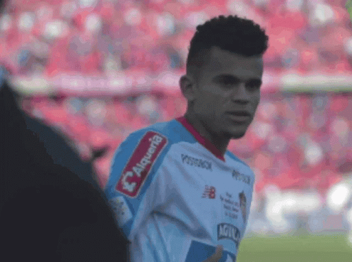A Soccer Player Wearing A White And Blue Jersey With The Word Alqueria On The Sleeve GIF