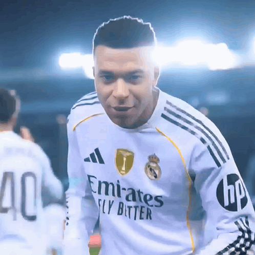 A Soccer Player Wearing A White Emirates Fly Bitter Jersey GIF