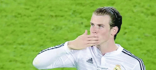 A Soccer Player Wearing A White Fly Emirates Jersey Is Waving His Hand . GIF