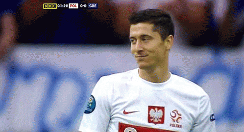 A Soccer Player Wearing A White Jersey With A Red Eagle On The Front GIF