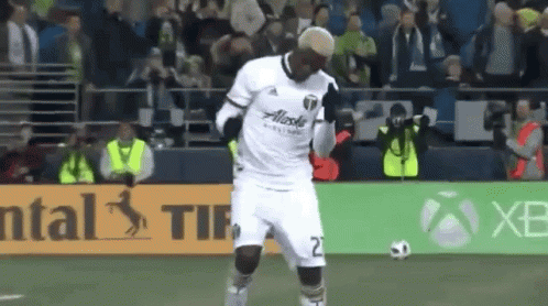 A Soccer Player Wearing A White Jersey With Alaska On The Front GIF