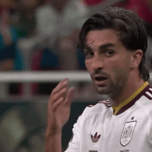 A Soccer Player Wearing A White Jersey With An Adidas Logo GIF