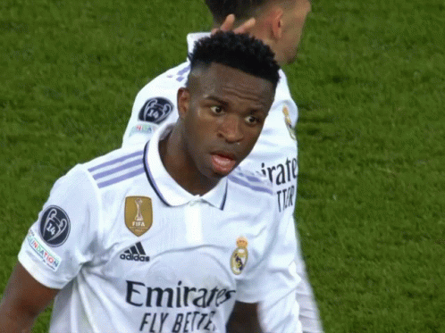 a soccer player wearing a white jersey with emirates fly better written on it