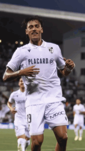 A Soccer Player Wearing A White Shirt That Says Placard On It GIF