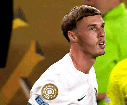 A Soccer Player Wearing A White Shirt With A Fifa Logo On His Sleeve GIF