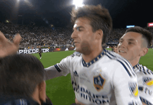 A Soccer Player Wearing A White Shirt With A Galaxy Logo On It GIF