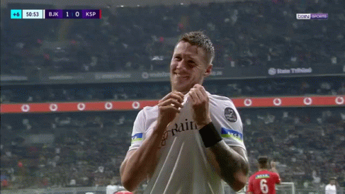 a soccer player wearing a white shirt with rain on it