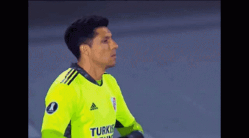 A Soccer Player Wearing A Yellow Adidas Jersey Is Standing On The Field . GIF