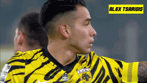A Soccer Player Wearing A Yellow And Black Jersey With The Name Alex Tsaridis GIF
